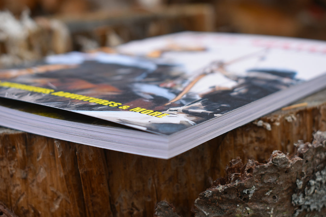 Close-up side view showing the thickness of Trad Hunters Magazine Vol. 2: High Country, highlighting the printed pages